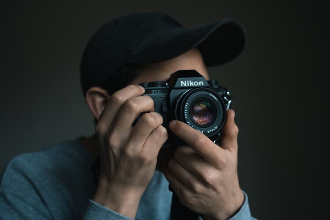 Photographer holding a camera preparing for a shoot
